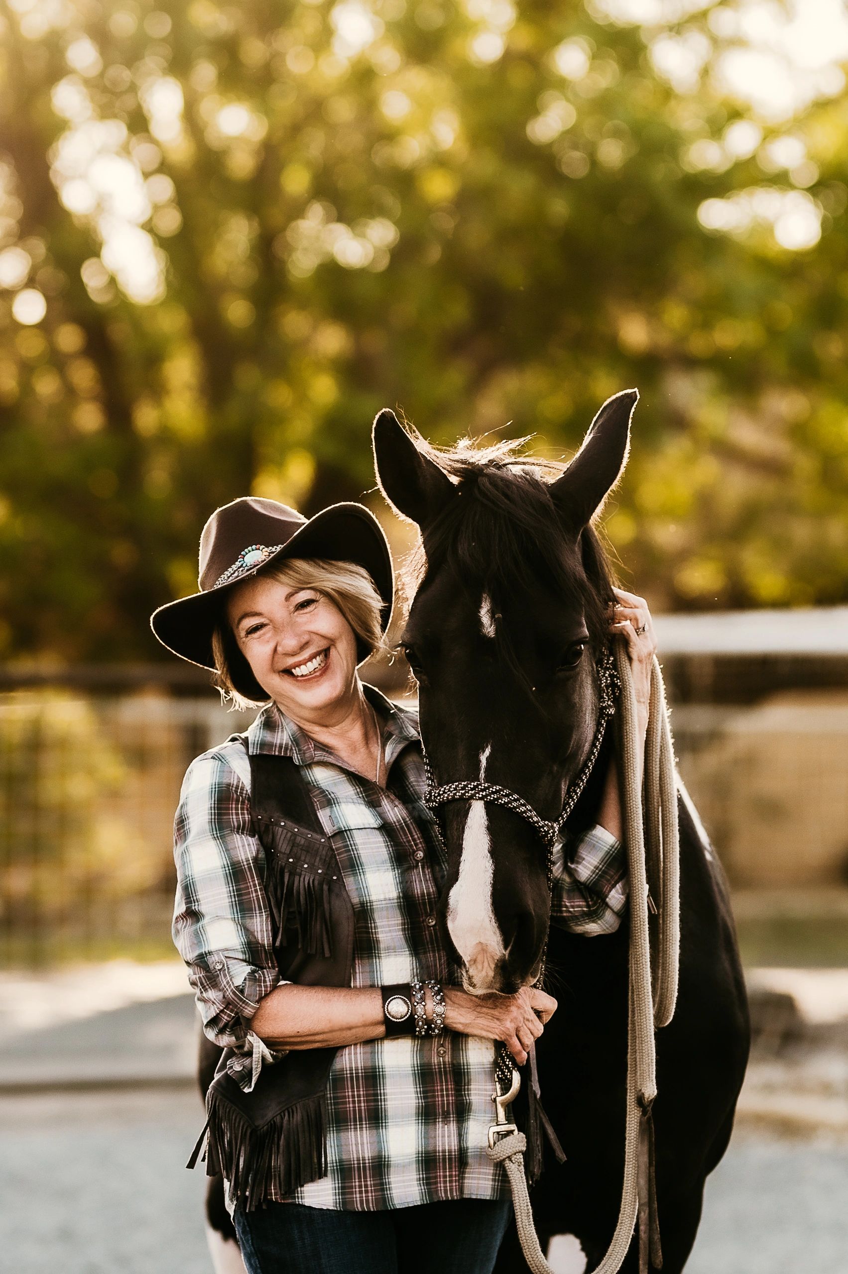 Woman with horse bokeh golden foliage